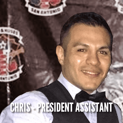 A man in vest and tie smiling for the camera.